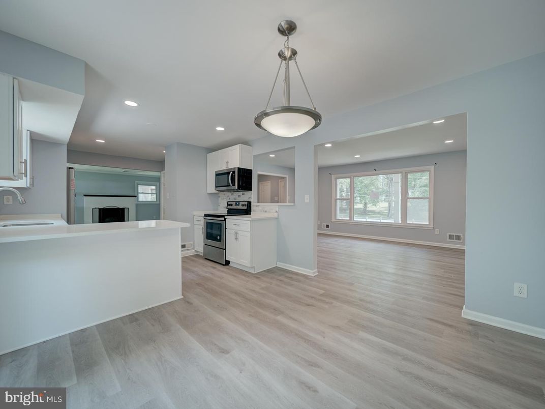 Empty room, Interior, Kitchen, Pendant Lights, Recessed Lighting, Stainless Steel Appliances, Wood Texture Flooring