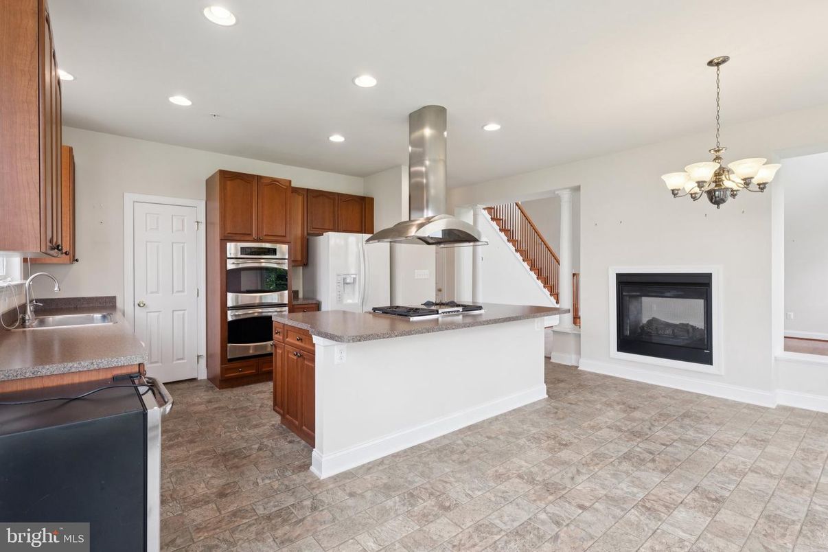 Chandelier, Fireplace, Interior, Kitchen, Recessed Lighting, Stainless Steel Appliances