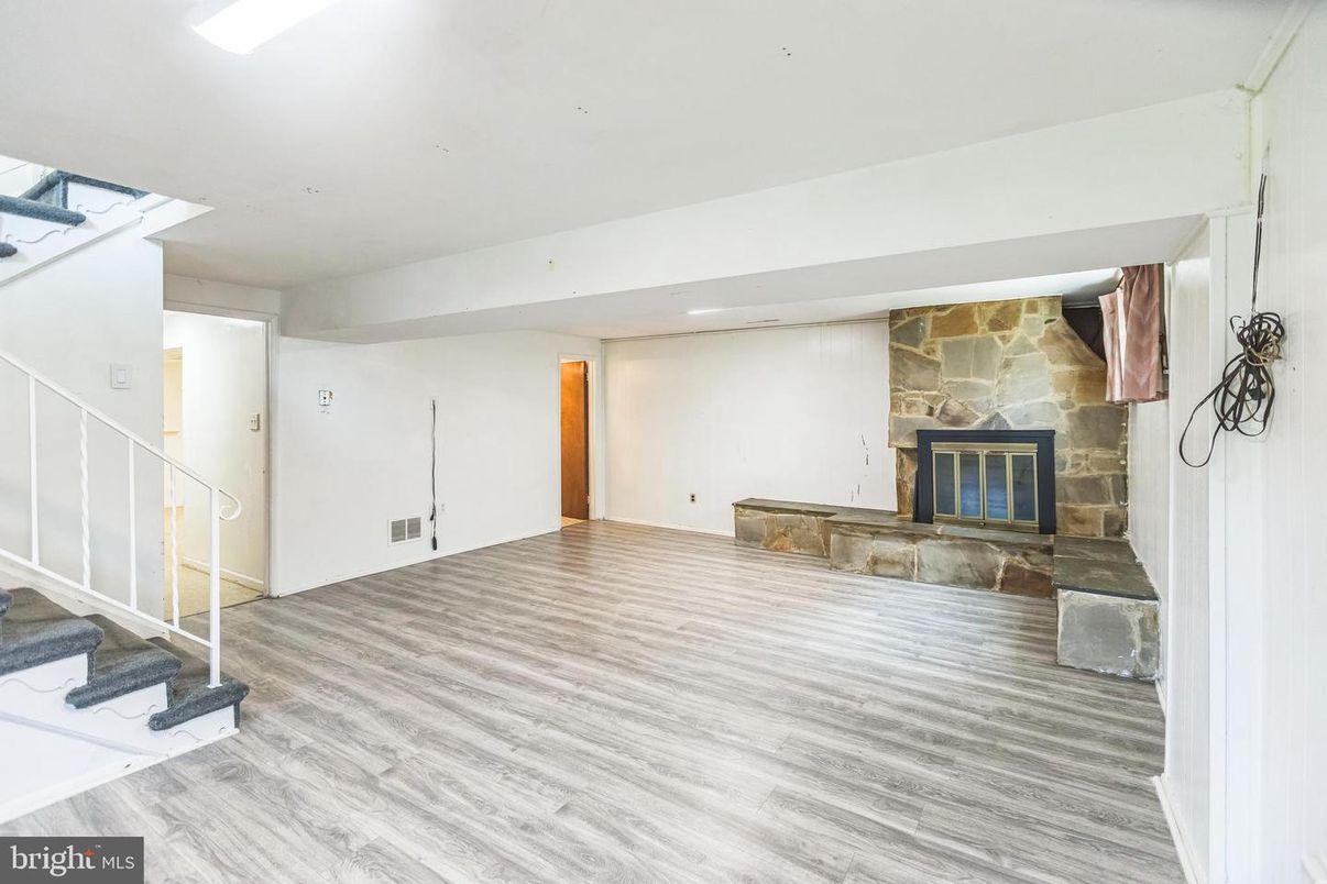 Empty room, Fireplace, Interior, Recessed Lighting, Stone Walls, Wood Texture Flooring