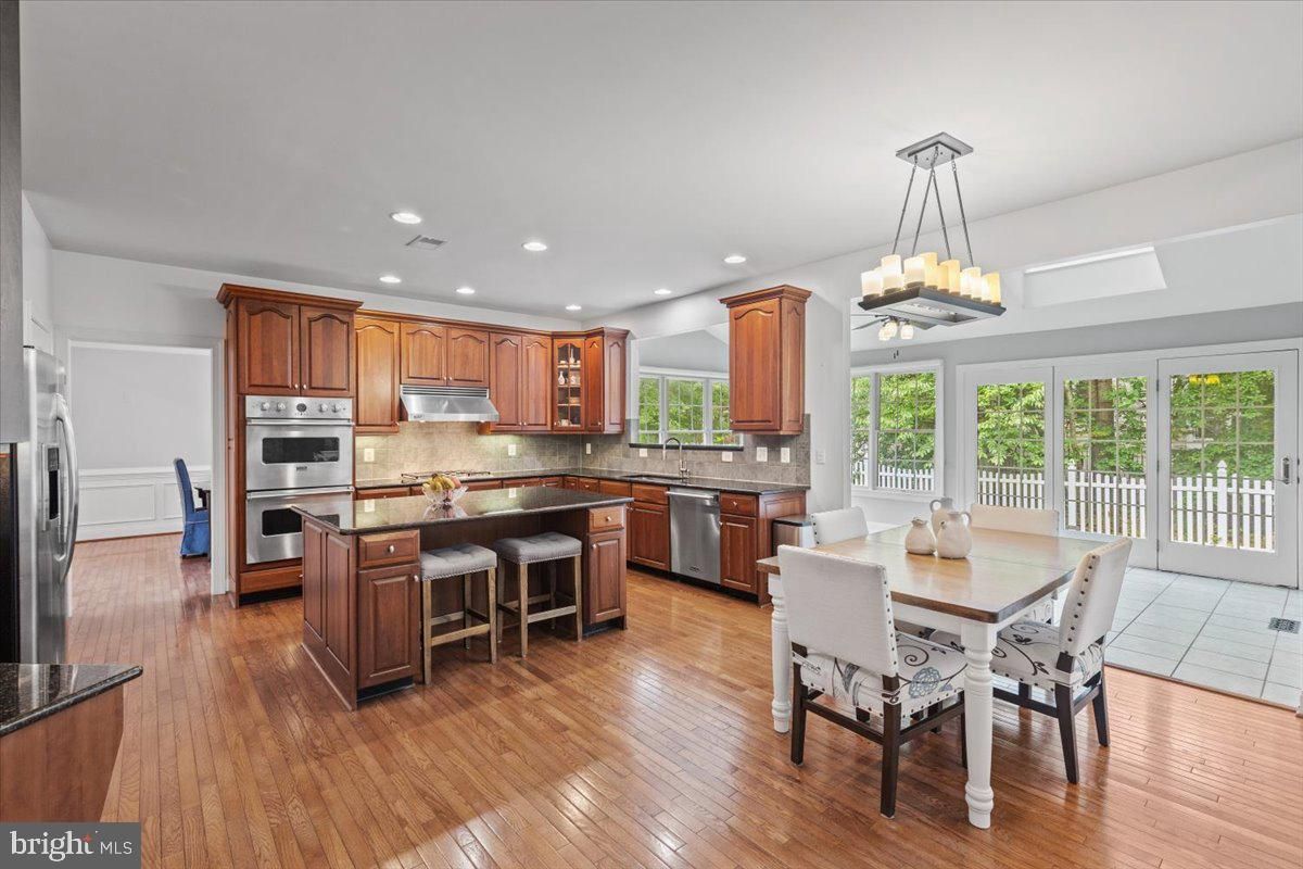 Chandelier, Dining room, Interior, Kitchen, Recessed Lighting, Stainless Steel Appliances, Wood Texture Flooring
