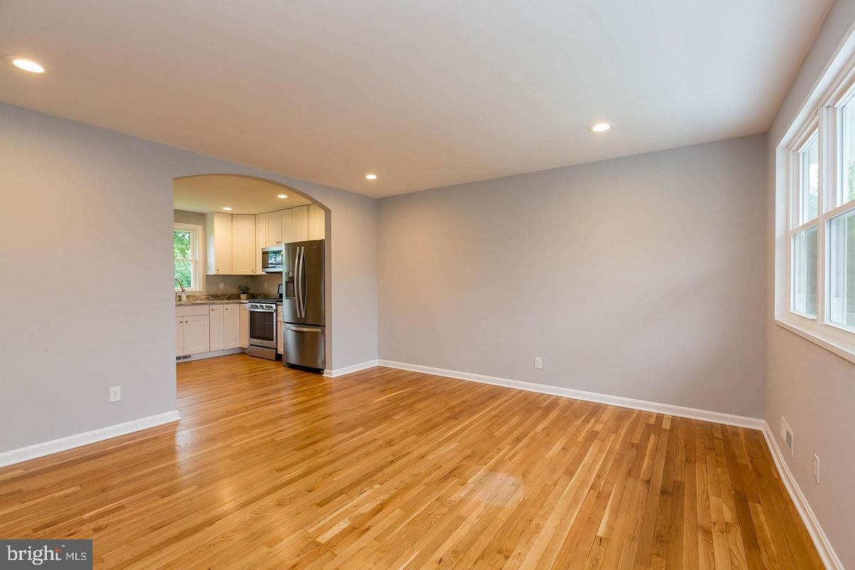 Empty room, Interior, Kitchen, Recessed Lighting, Stainless Steel Appliances, Wood Texture Flooring