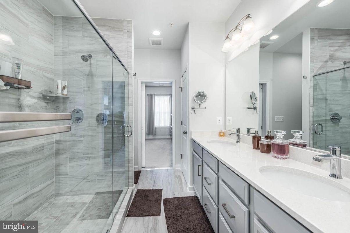 Bathroom, Dual Sink Vanities, Glass Shower, Interior, Marble, Marble Walls, Recessed Lighting, Wood Texture Flooring