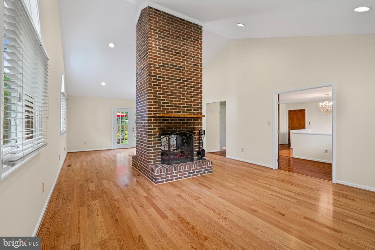 Chandelier, Empty room, Fireplace, Interior, Recessed Lighting, Stone Walls, Wood Texture Flooring