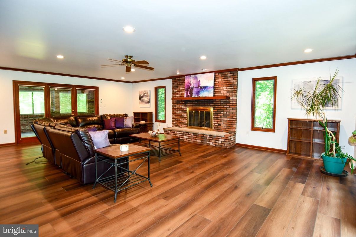 Fireplace, Interior, Living room, Recessed Lighting, Stone Walls, Wood Texture Flooring