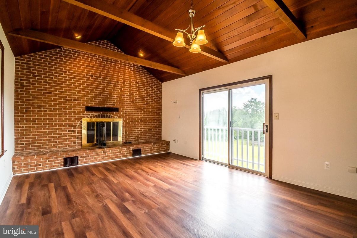 Empty room, Fireplace, Interior, Pendant Lights, Recessed Lighting, Stone Walls, Wooden Beams, Wooden Ceilings, Wood Texture Flooring