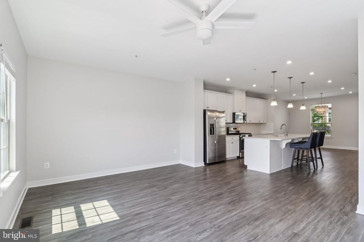 Empty room, Interior, Kitchen, Pendant Lights, Recessed Lighting, Stainless Steel Appliances, Wood Texture Flooring