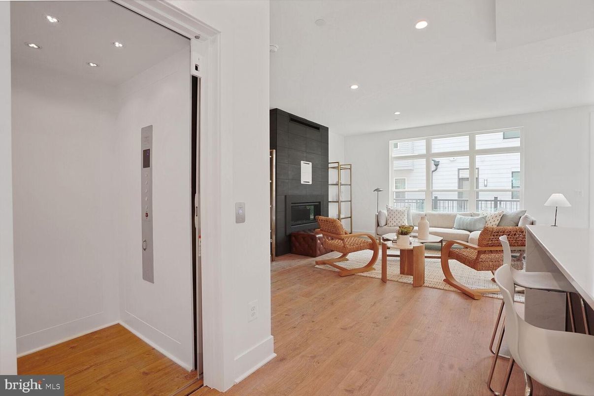 Elevator, Fireplace, Interior, Living room, Recessed Lighting, Wood Texture Flooring