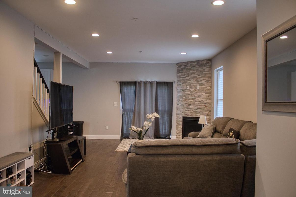 Fireplace, Interior, Living room, Recessed Lighting, Stone Walls, Wood Texture Flooring