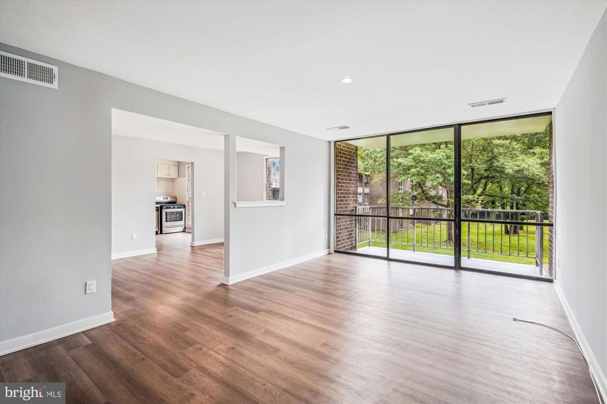 Empty room, Interior, Kitchen, Recessed Lighting, Stainless Steel Appliances, Wood Texture Flooring