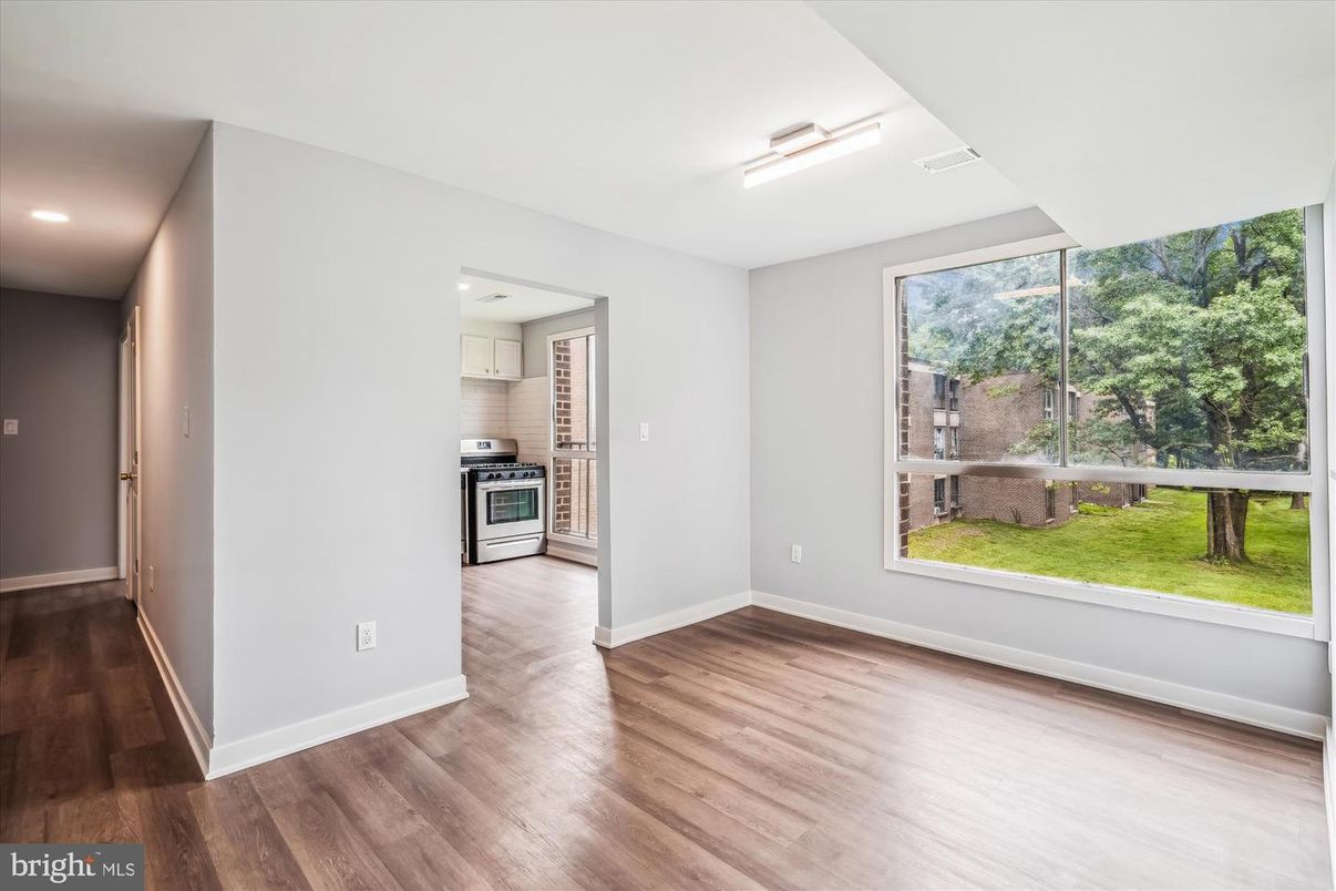 Empty room, Interior, Kitchen, Recessed Lighting, Stainless Steel Appliances, Wood Texture Flooring