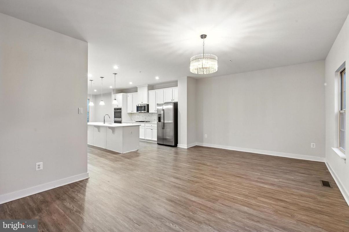 Chandelier, Empty room, Interior, Kitchen, Pendant Lights, Recessed Lighting, Stainless Steel Appliances, Wood Texture Flooring