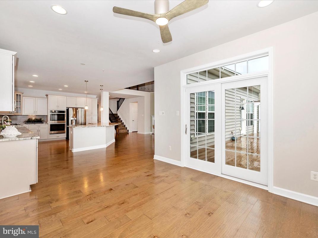 Empty room, Interior, Kitchen, Pendant Lights, Recessed Lighting, Stainless Steel Appliances, Wood Texture Flooring