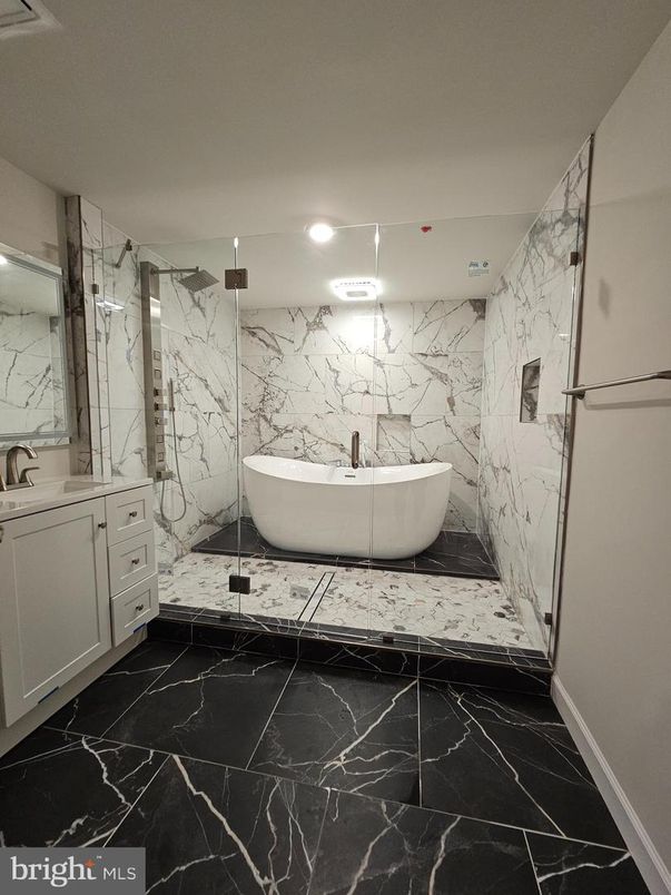 Bathroom, Free Standing Baths, Glass Shower, Interior, Marble, Marble Walls, Recessed Lighting