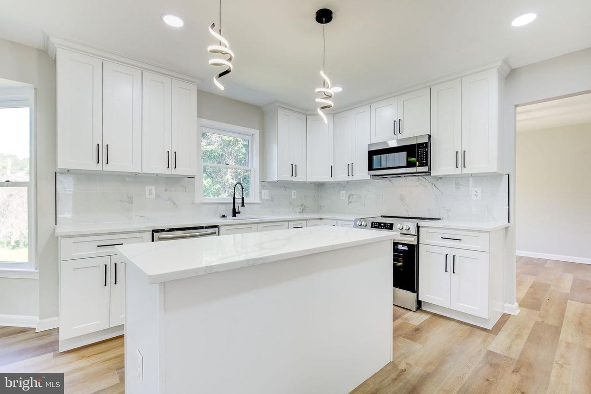 Interior, Kitchen, Marble Walls, Pendant Lights, Recessed Lighting, Stainless Steel Appliances, Wood Texture Flooring
