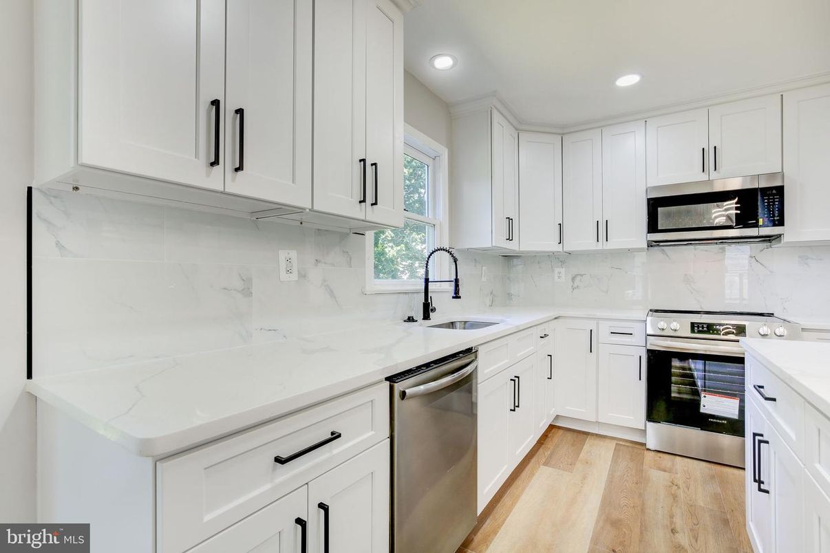 Interior, Kitchen, Marble Walls, Recessed Lighting, Stainless Steel Appliances, Wood Texture Flooring