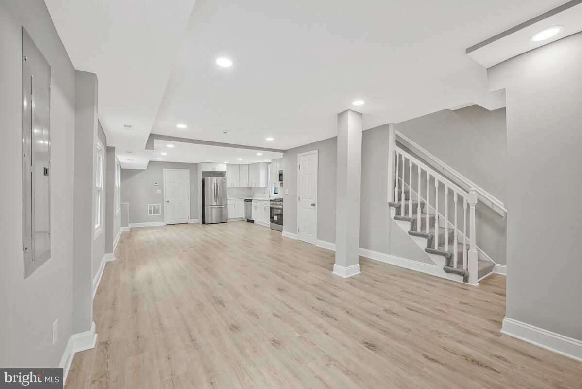 Empty room, Interior, Kitchen, Recessed Lighting, Stainless Steel Appliances, Wood Texture Flooring