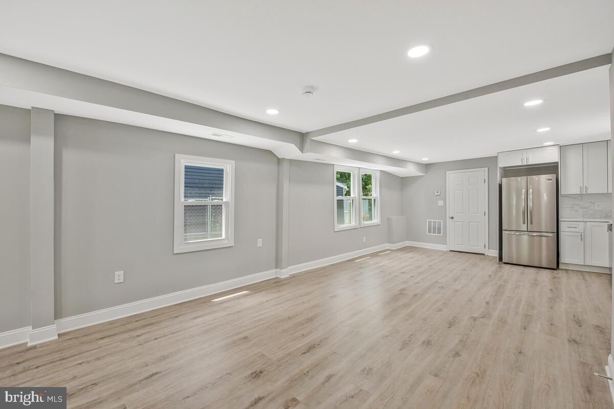 Empty room, Interior, Kitchen, Recessed Lighting, Stainless Steel Appliances, Wood Texture Flooring