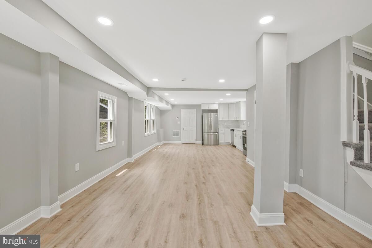 Empty room, Interior, Kitchen, Recessed Lighting, Stainless Steel Appliances, Wood Texture Flooring
