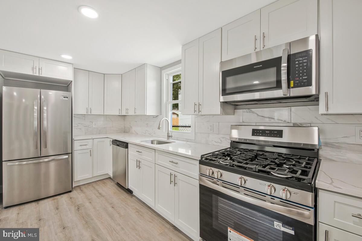 Interior, Kitchen, Marble Walls, Recessed Lighting, Stainless Steel Appliances, Wood Texture Flooring