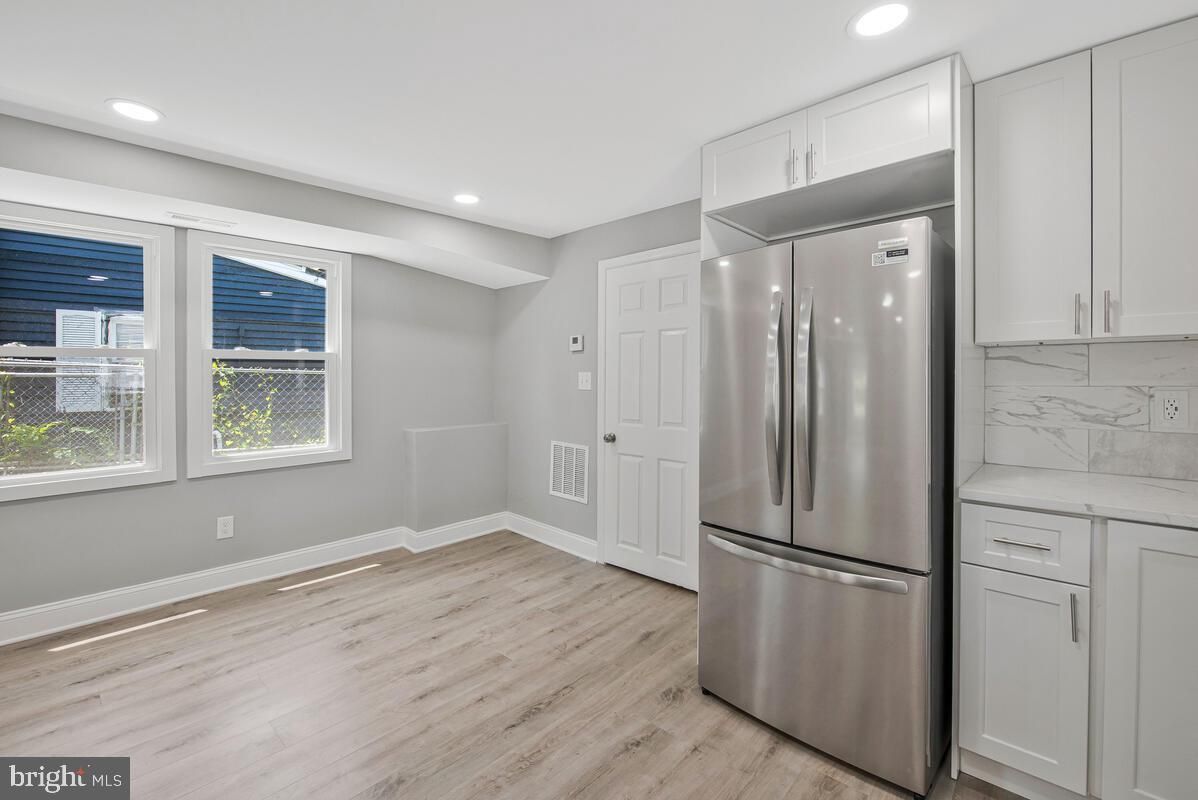 Interior, Kitchen, Marble Walls, Recessed Lighting, Stainless Steel Appliances, Wood Texture Flooring