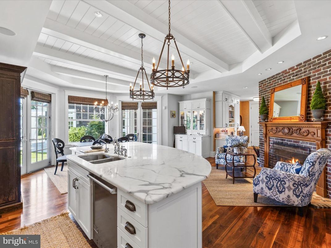 Chandelier, Dining room, Fireplace, Interior, Kitchen, Living room, Pendant Lights, Recessed Lighting, Stainless Steel Appliances, Stone Walls, Wood Texture Flooring