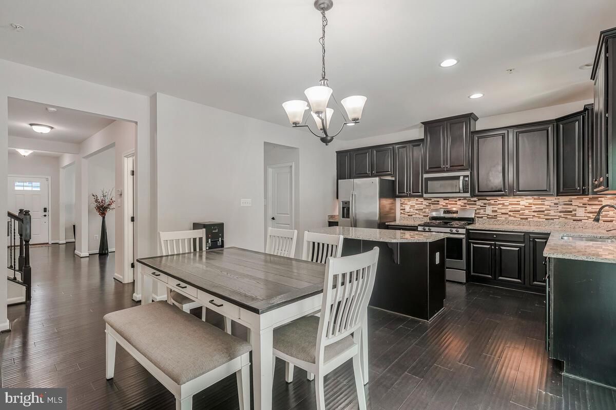 Chandelier, Dining room, Interior, Kitchen, Pendant Lights, Recessed Lighting, Stainless Steel Appliances, Wood Texture Flooring