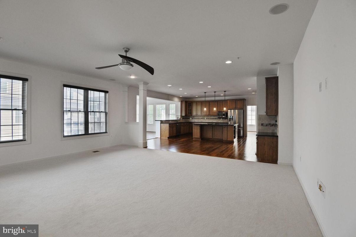 Empty room, Interior, Kitchen, Recessed Lighting, Stainless Steel Appliances, Wood Texture Flooring
