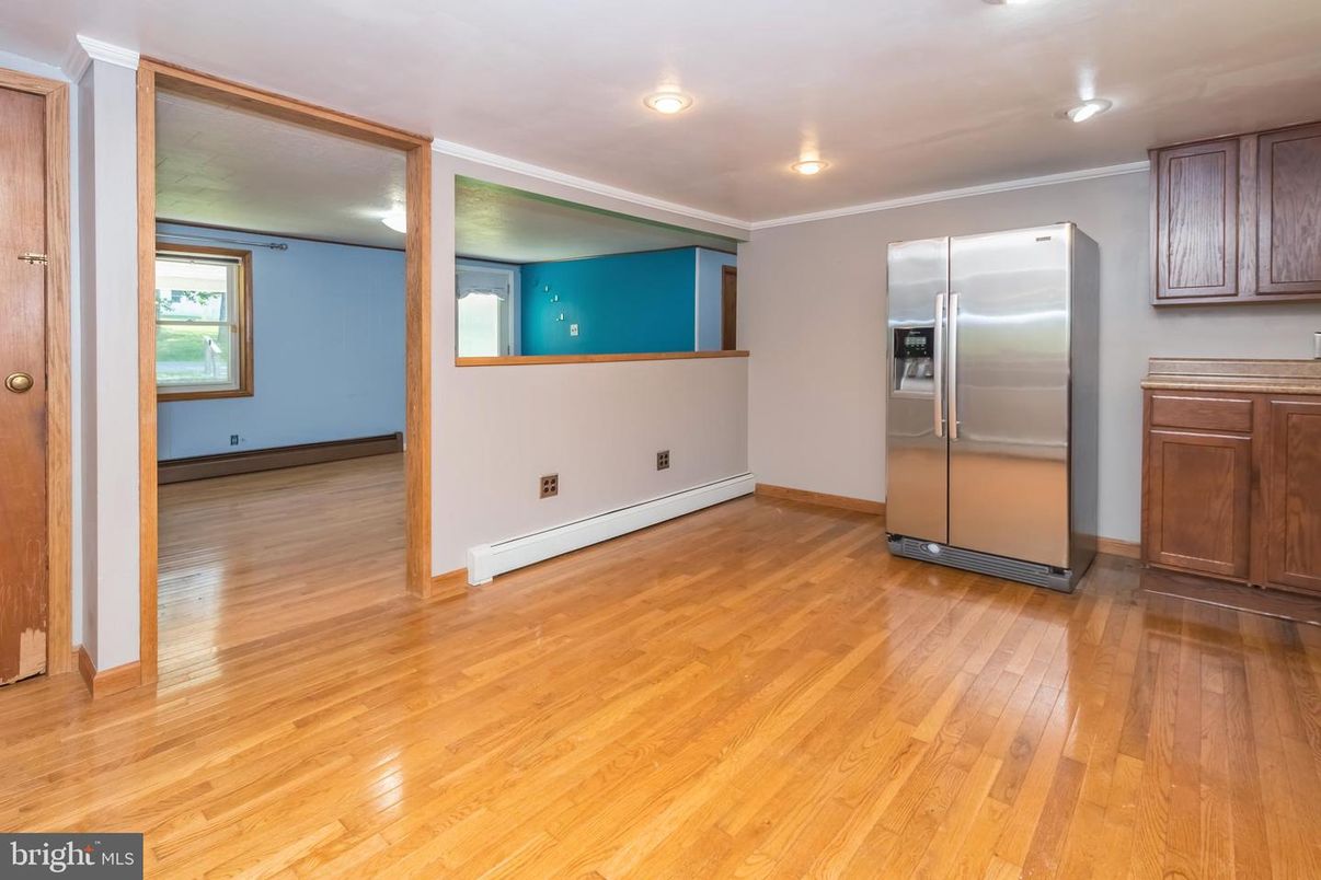Empty room, Interior, Kitchen, Recessed Lighting, Stainless Steel Appliances, Wood Texture Flooring