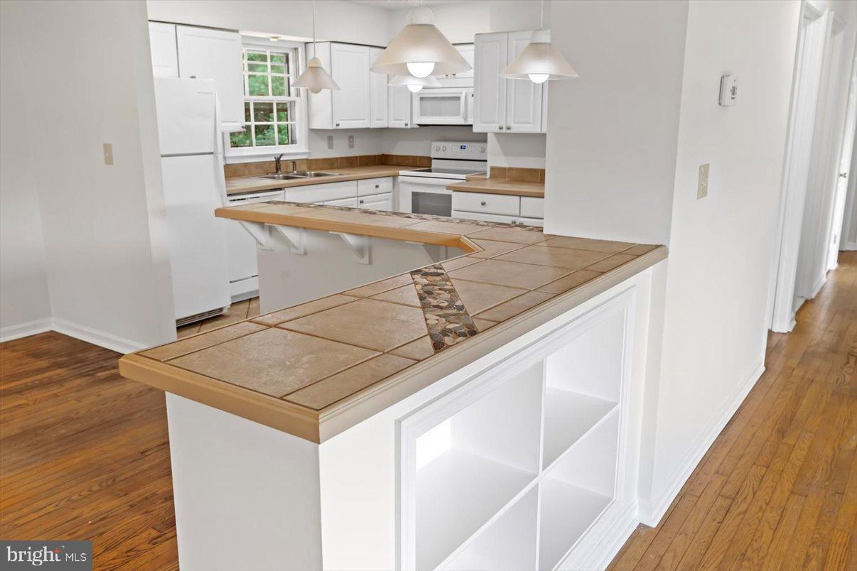Interior, Kitchen, Pendant Lights, Tile Countertops, Wood Texture Flooring
