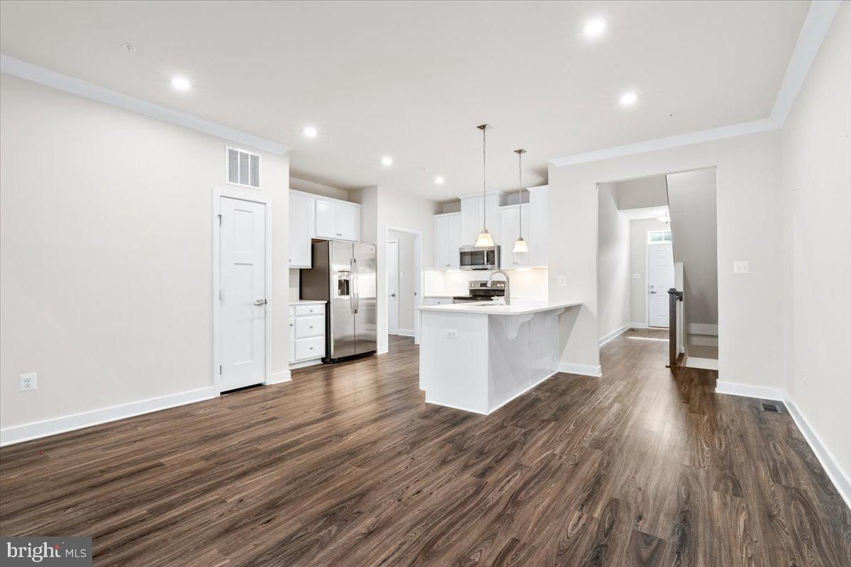 Empty room, Interior, Kitchen, Pendant Lights, Recessed Lighting, Stainless Steel Appliances, Wood Texture Flooring