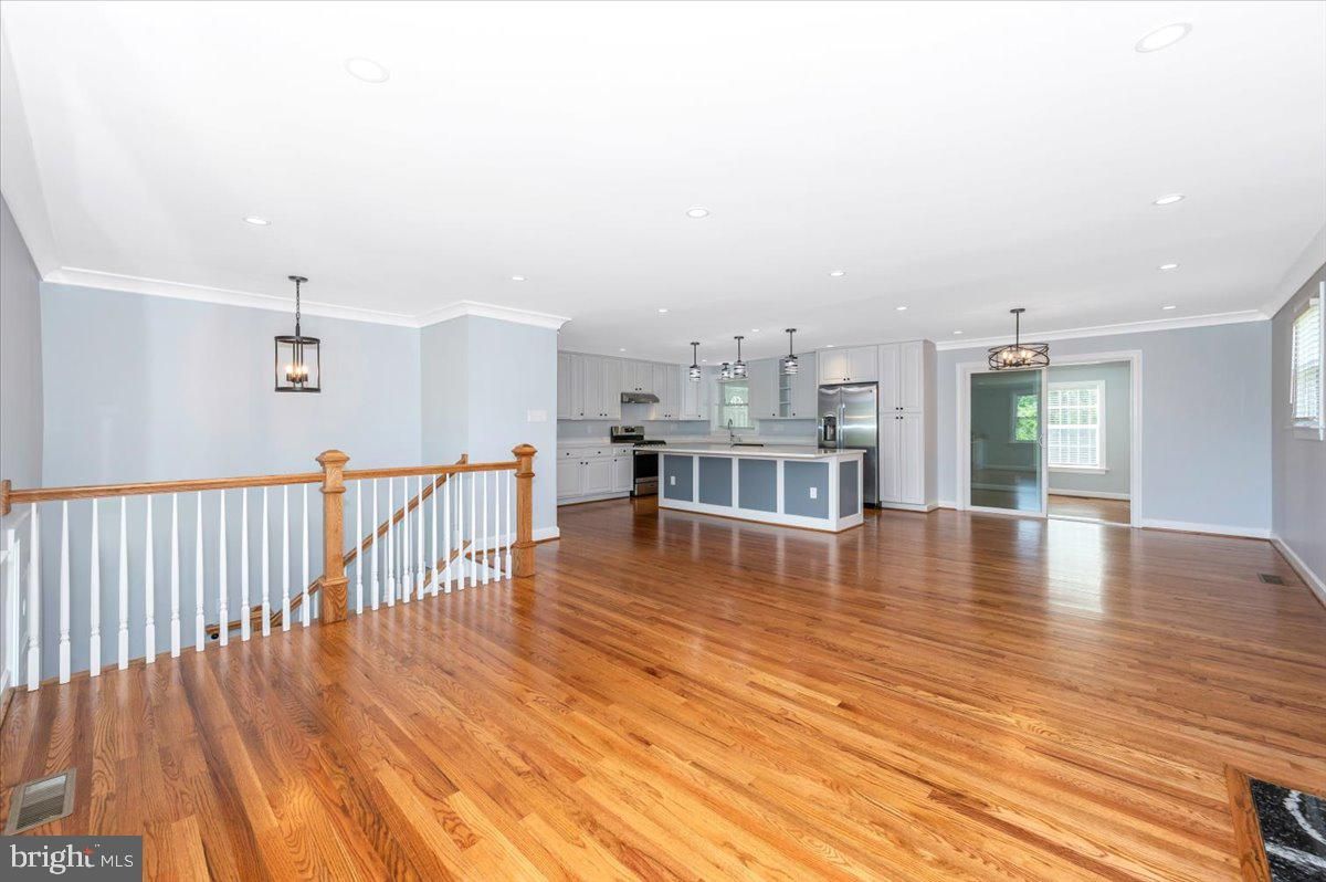 Empty room, Interior, Kitchen, Pendant Lights, Recessed Lighting, Stainless Steel Appliances, Wood Texture Flooring