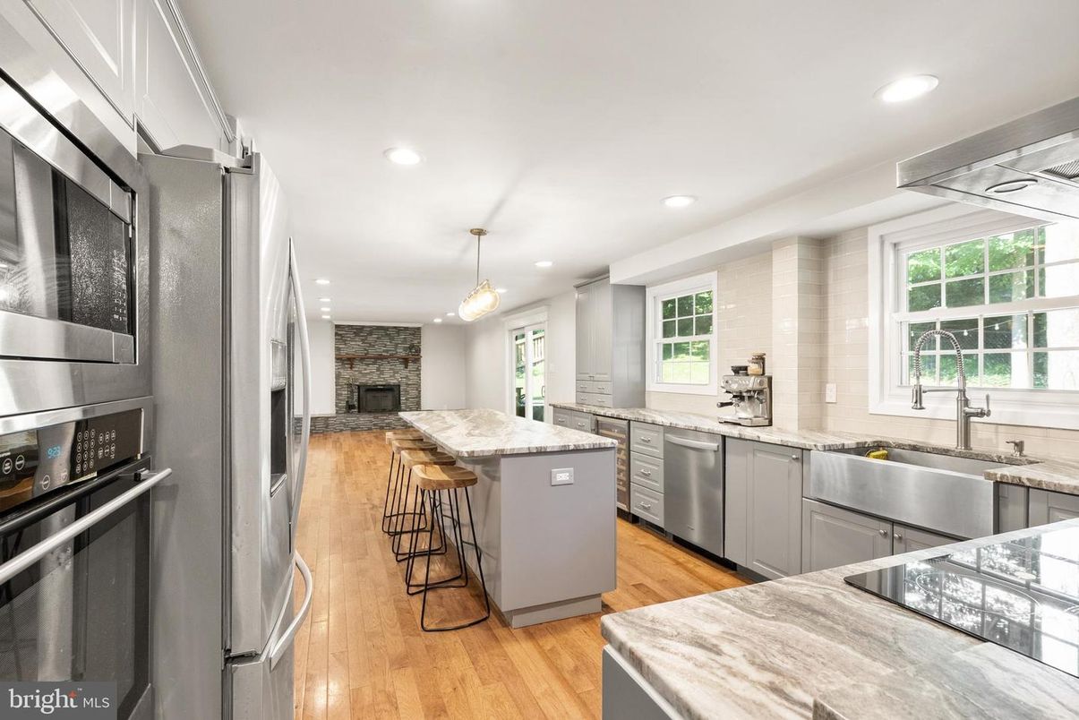 Fireplace, Interior, Kitchen, Pendant Lights, Recessed Lighting, Stainless Steel Appliances, Stone Walls, Wood Texture Flooring