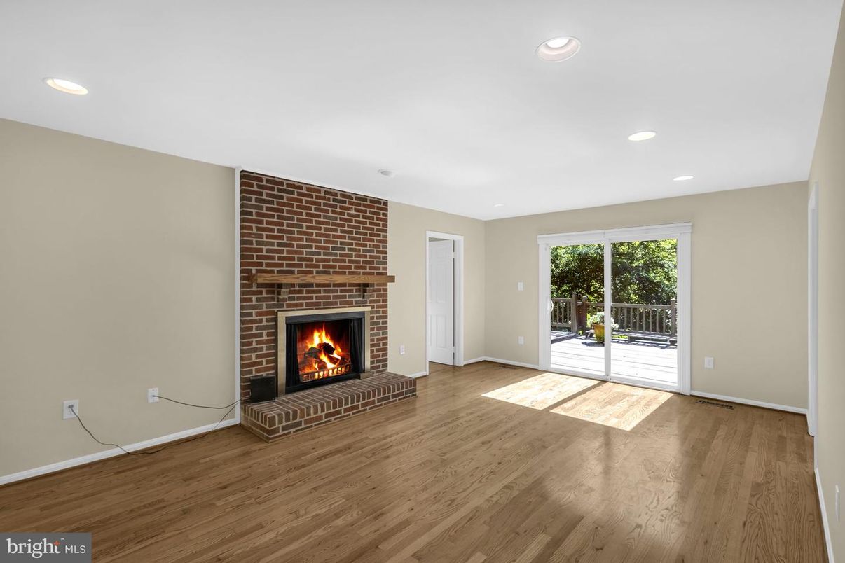 Empty room, Fireplace, Interior, Recessed Lighting, Stone Walls, Wood Texture Flooring
