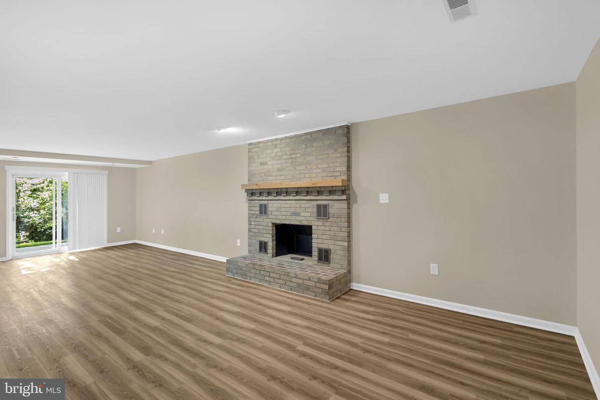 Empty room, Fireplace, Interior, Recessed Lighting, Stone Walls, Wood Texture Flooring