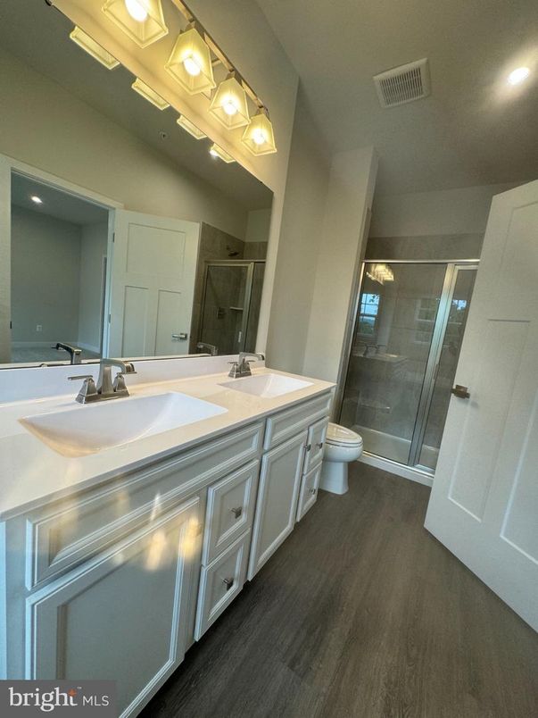 Bathroom, Dual Sink Vanities, Glass Shower, Interior, Recessed Lighting, Wood Texture Flooring