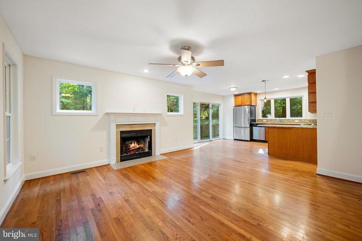 Empty room, Fireplace, Interior, Kitchen, Pendant Lights, Recessed Lighting, Stainless Steel Appliances, Wood Texture Flooring