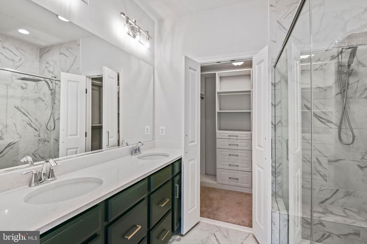 Bathroom, Dual Sink Vanities, Glass Shower, Interior, Marble, Marble Walls, Recessed Lighting, Walk-in Closets