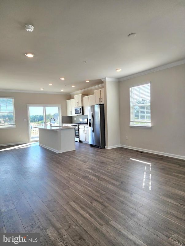 Empty room, Interior, Kitchen, Recessed Lighting, Stainless Steel Appliances, Wood Texture Flooring
