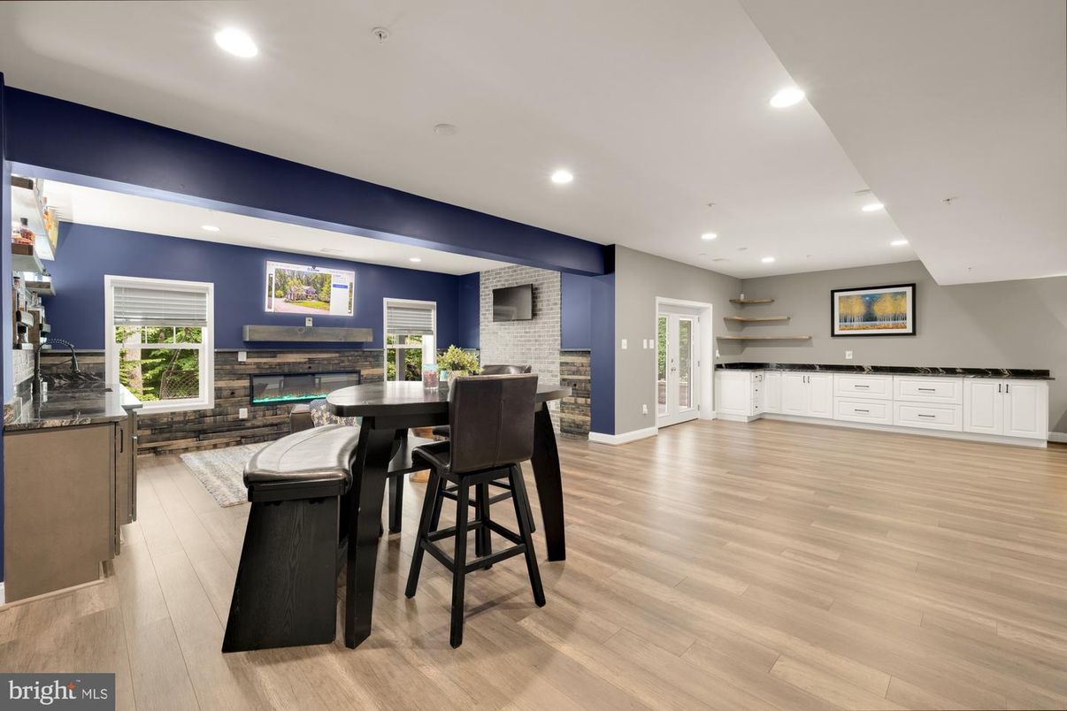Dining room, Fireplace, Interior, Recessed Lighting, Stone Walls, Wood Texture Flooring