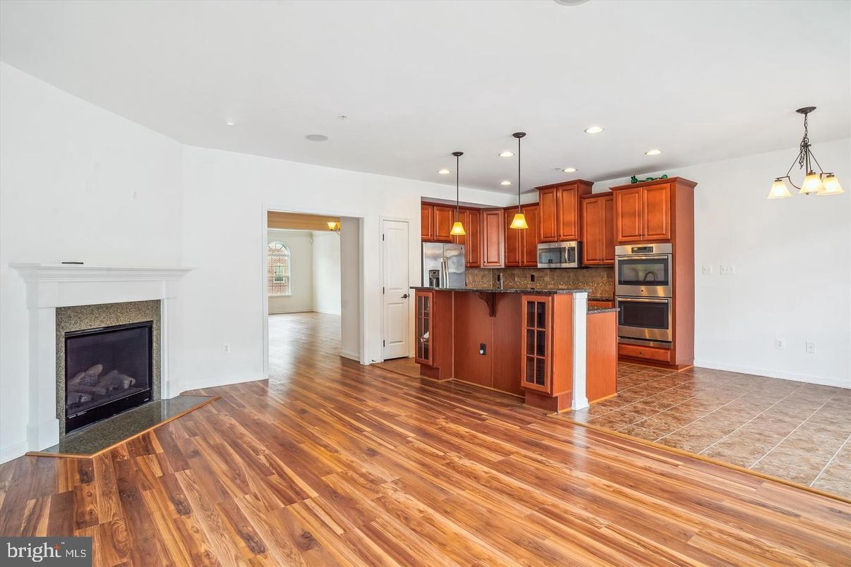 Empty room, Fireplace, Interior, Kitchen, Pendant Lights, Recessed Lighting, Wood Texture Flooring
