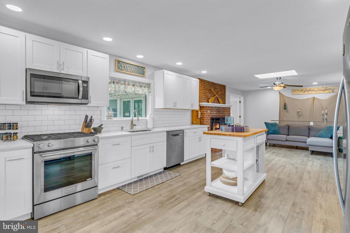 Fireplace, Interior, Kitchen, Recessed Lighting, Stainless Steel Appliances, Stone Walls, Wood Texture Flooring
