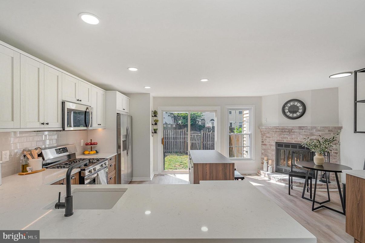 Fireplace, Interior, Kitchen, Recessed Lighting, Stainless Steel Appliances, Wood Texture Flooring