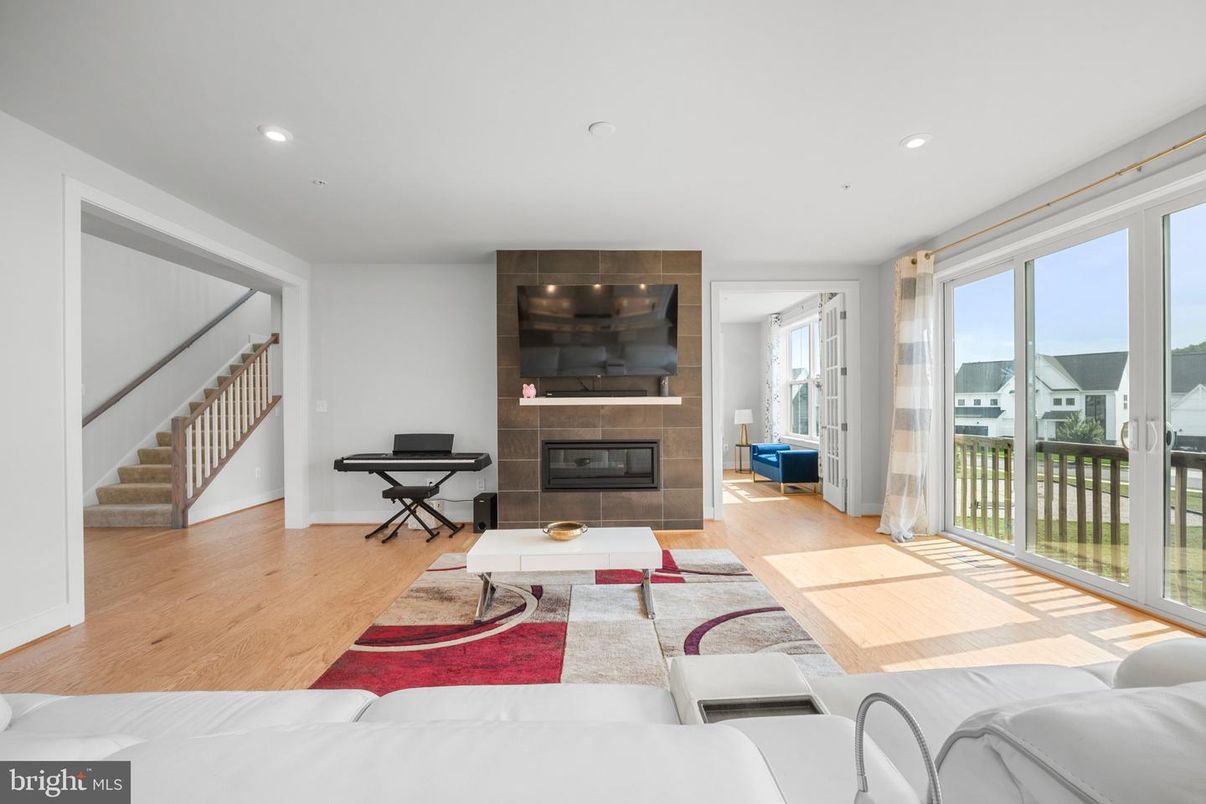 Fireplace, Interior, Living room, Piano, Recessed Lighting, Wood Texture Flooring