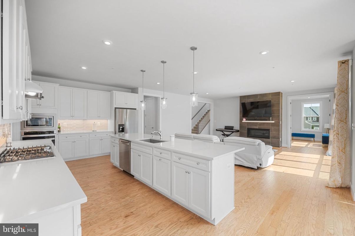 Fireplace, Interior, Kitchen, Living room, Pendant Lights, Recessed Lighting, Stainless Steel Appliances, Wood Texture Flooring