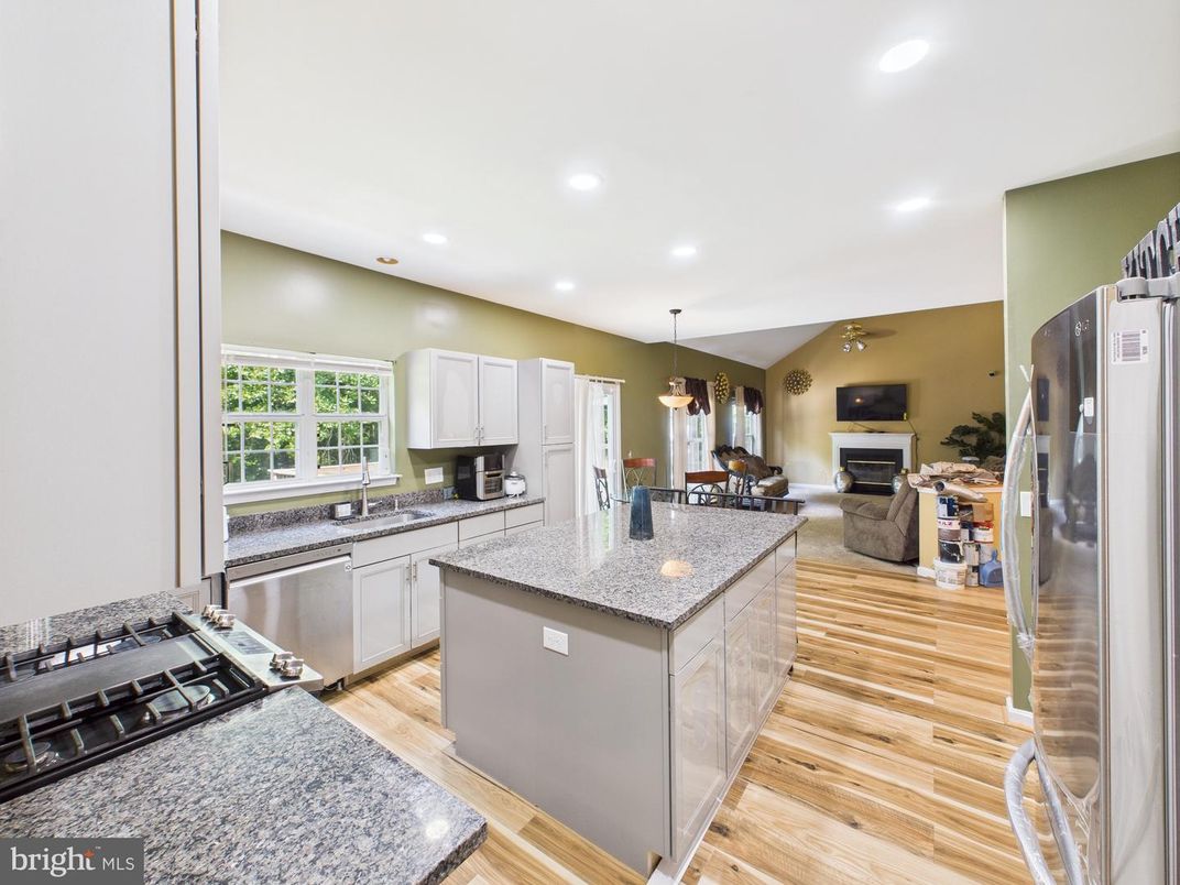 Dining room, Fireplace, Interior, Kitchen, Living room, Pendant Lights, Recessed Lighting, Stainless Steel Appliances, Wood Texture Flooring