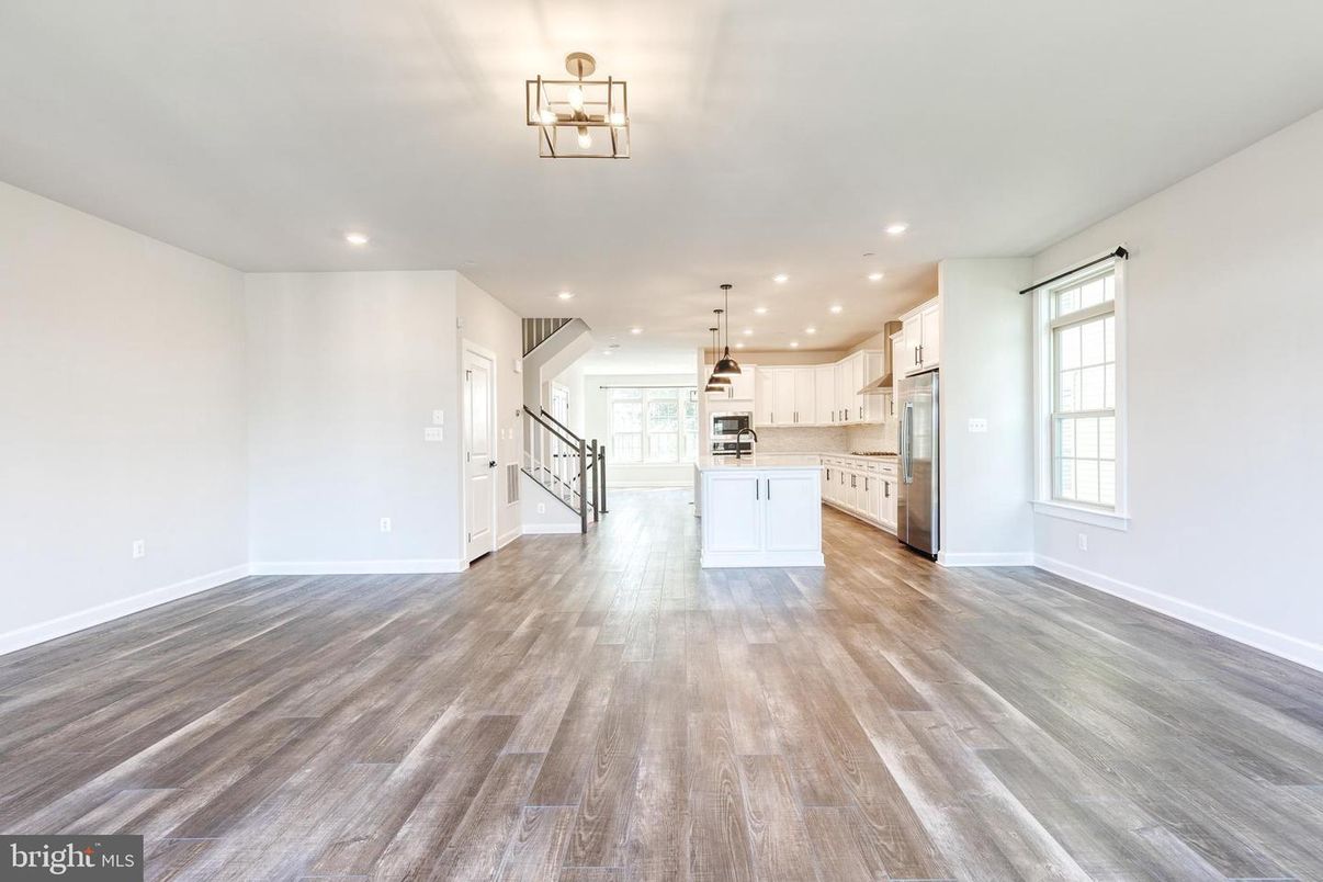 Empty room, Interior, Kitchen, Pendant Lights, Recessed Lighting, Stainless Steel Appliances, Wood Texture Flooring