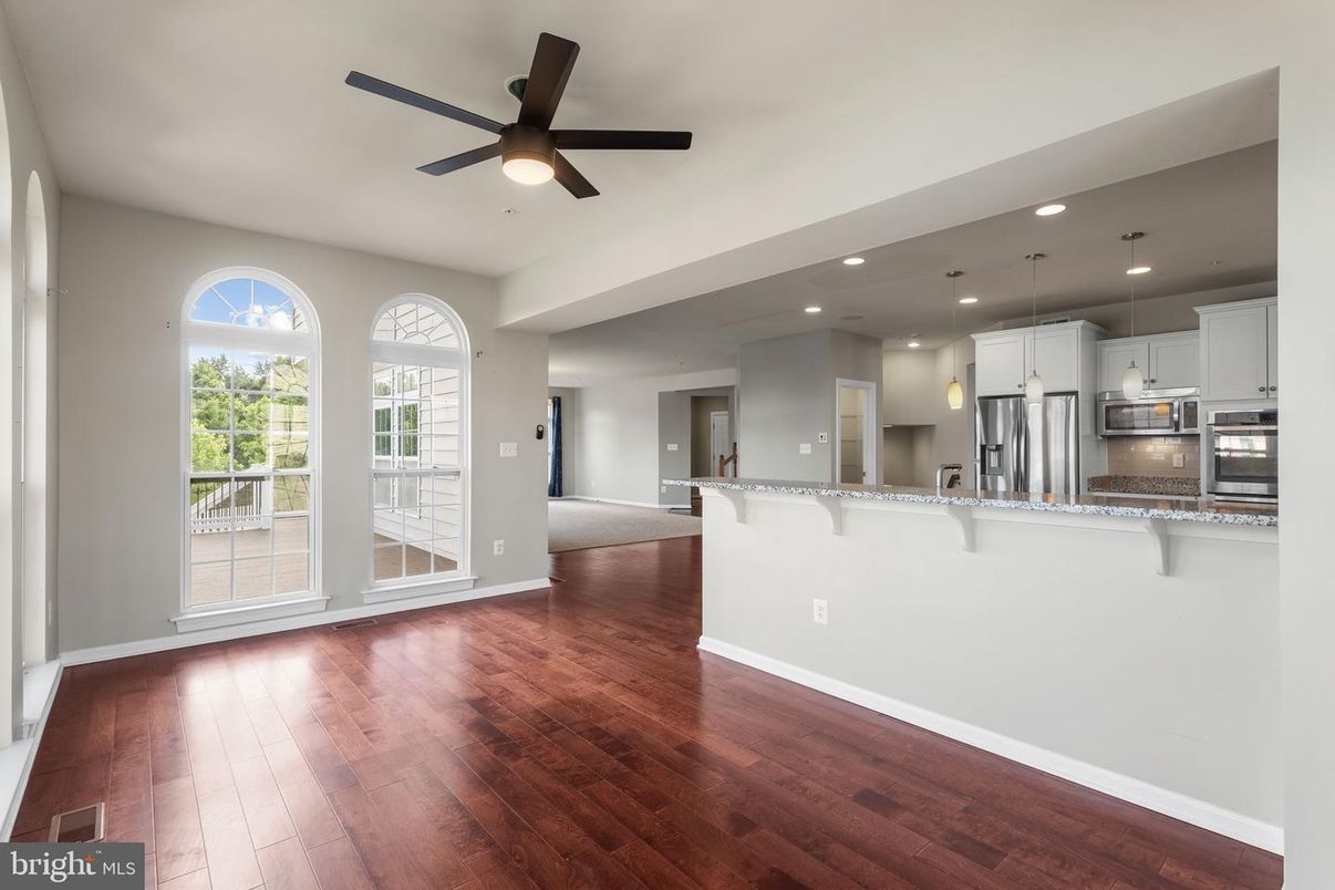 Empty room, Interior, Kitchen, Pendant Lights, Recessed Lighting, Stainless Steel Appliances, Wood Texture Flooring