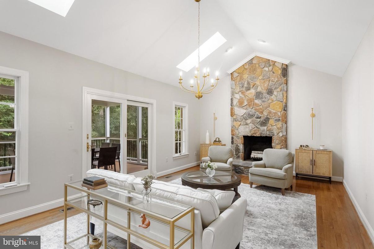 Chandelier, Fireplace, Interior, Living room, Recessed Lighting, Stone Walls, Wood Texture Flooring