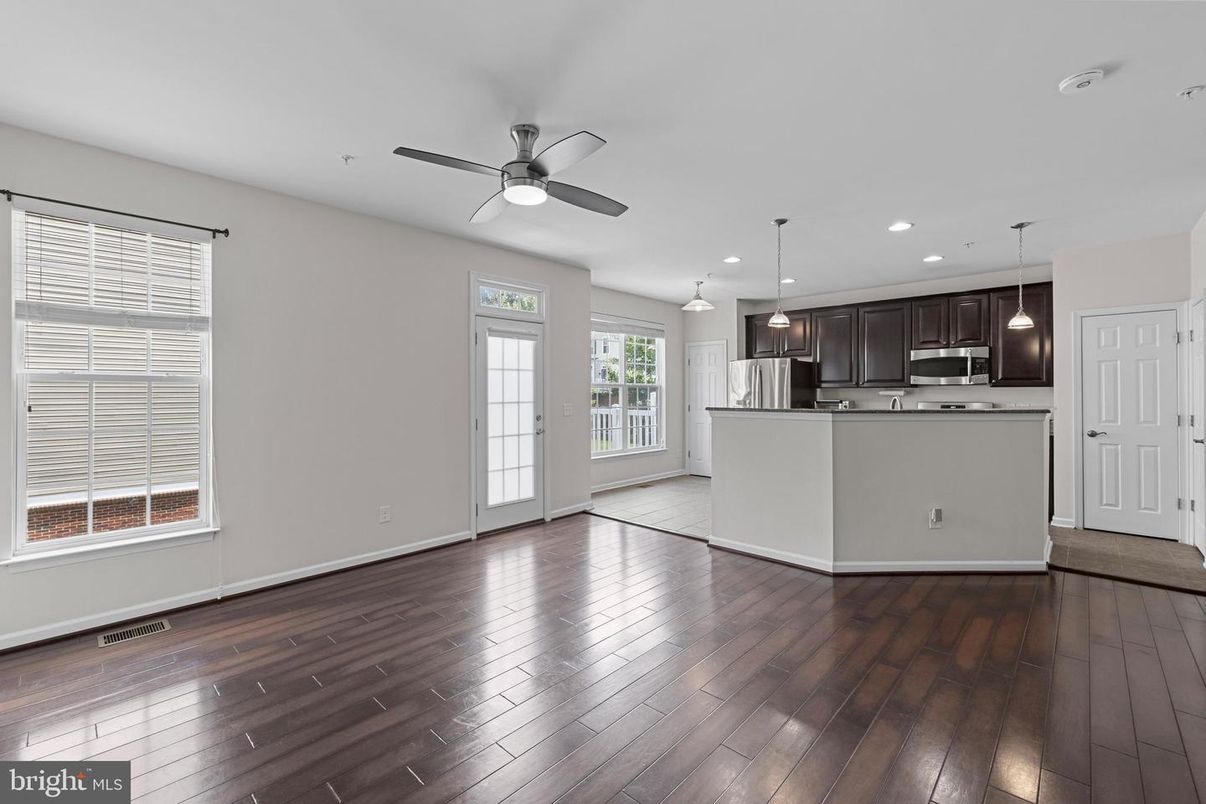 Empty room, Interior, Kitchen, Pendant Lights, Recessed Lighting, Stainless Steel Appliances, Wood Texture Flooring