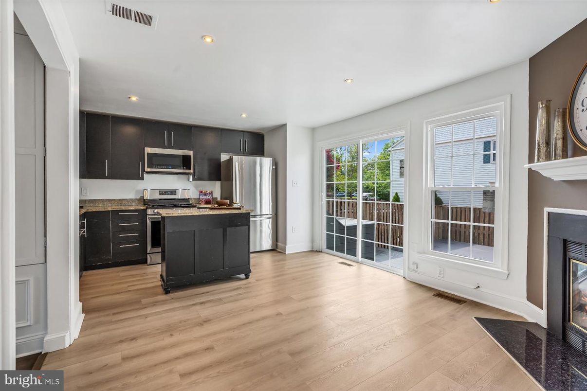 Fireplace, Interior, Kitchen, Recessed Lighting, Stainless Steel Appliances, Wood Texture Flooring